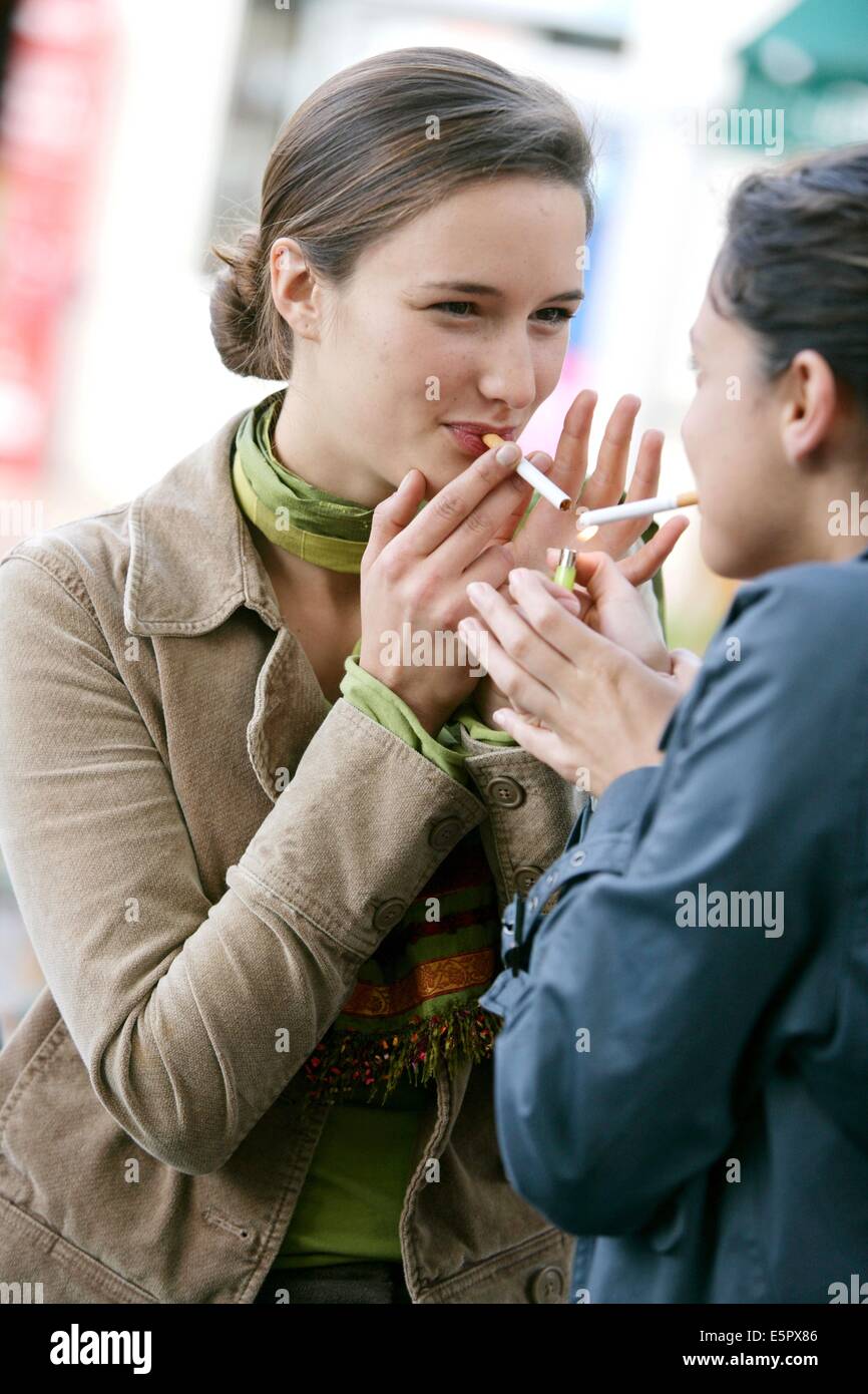 Women smoking outside of their office. Stock Photo