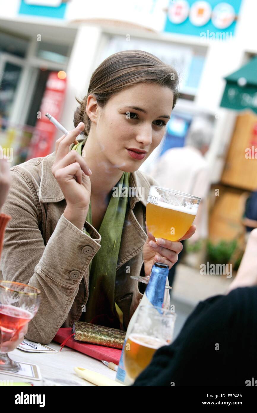 Women smoking and drinking at a terrasse. Stock Photo