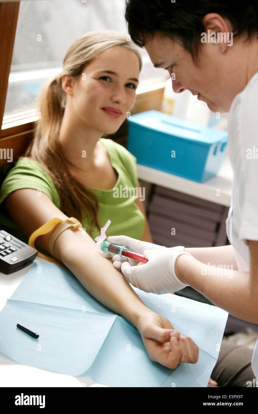 Midwife taking blood sample from a pregnant woman at antenatal