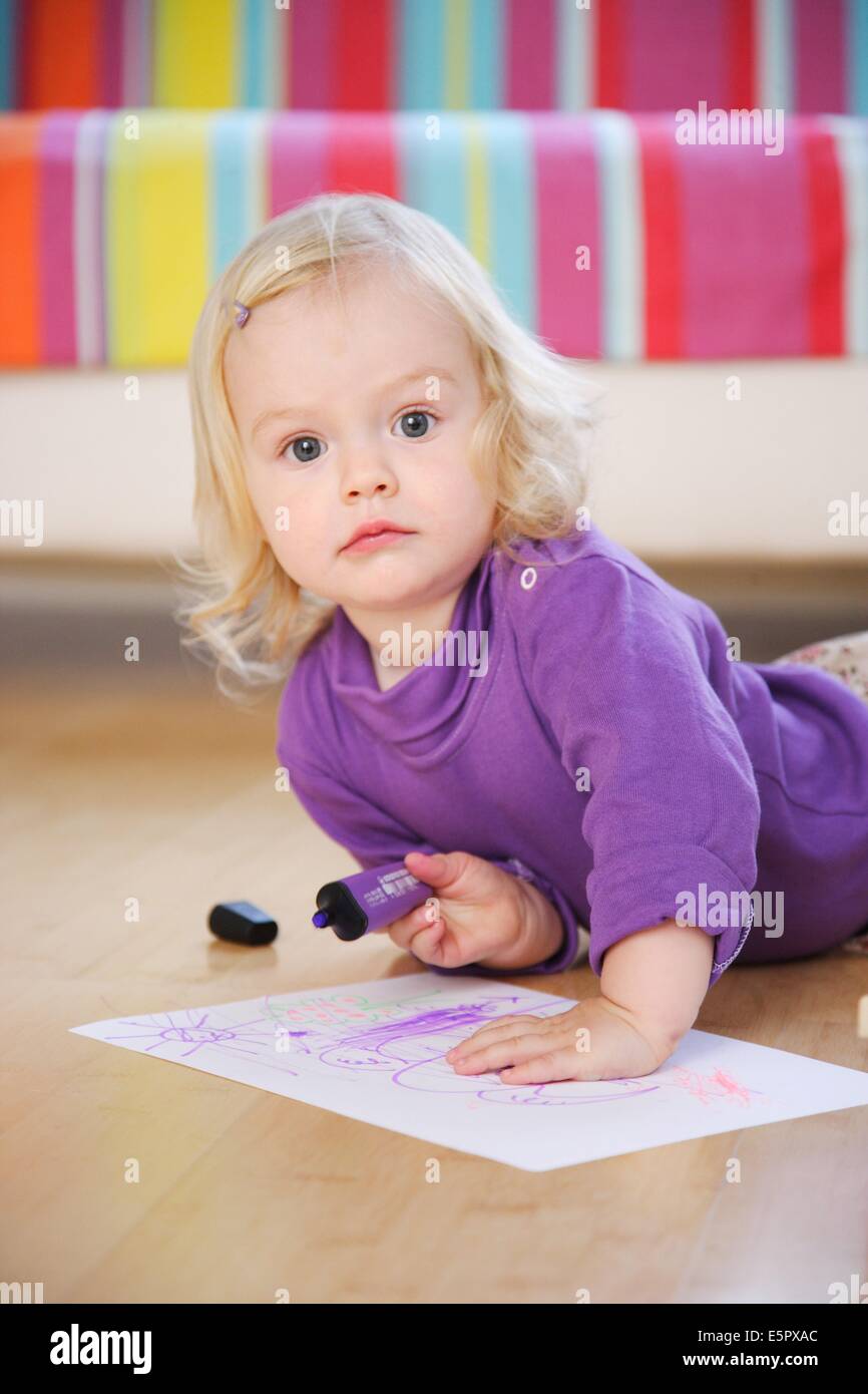 18 month old baby girl drawing. Stock Photo