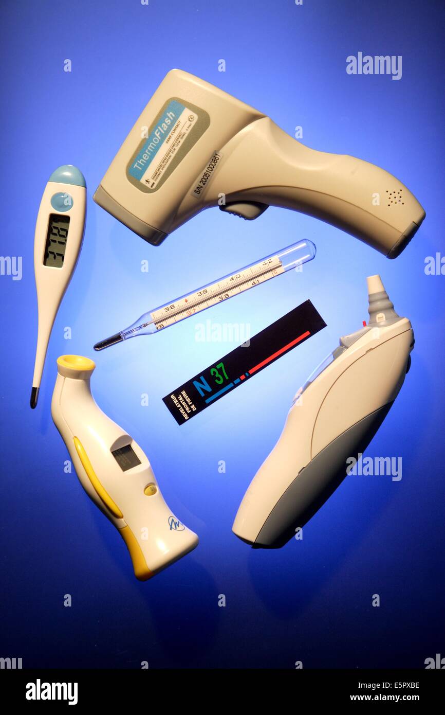 Different thermometers, ear or forehead thermometer, strip thermometer and infrared thermometer. Stock Photo