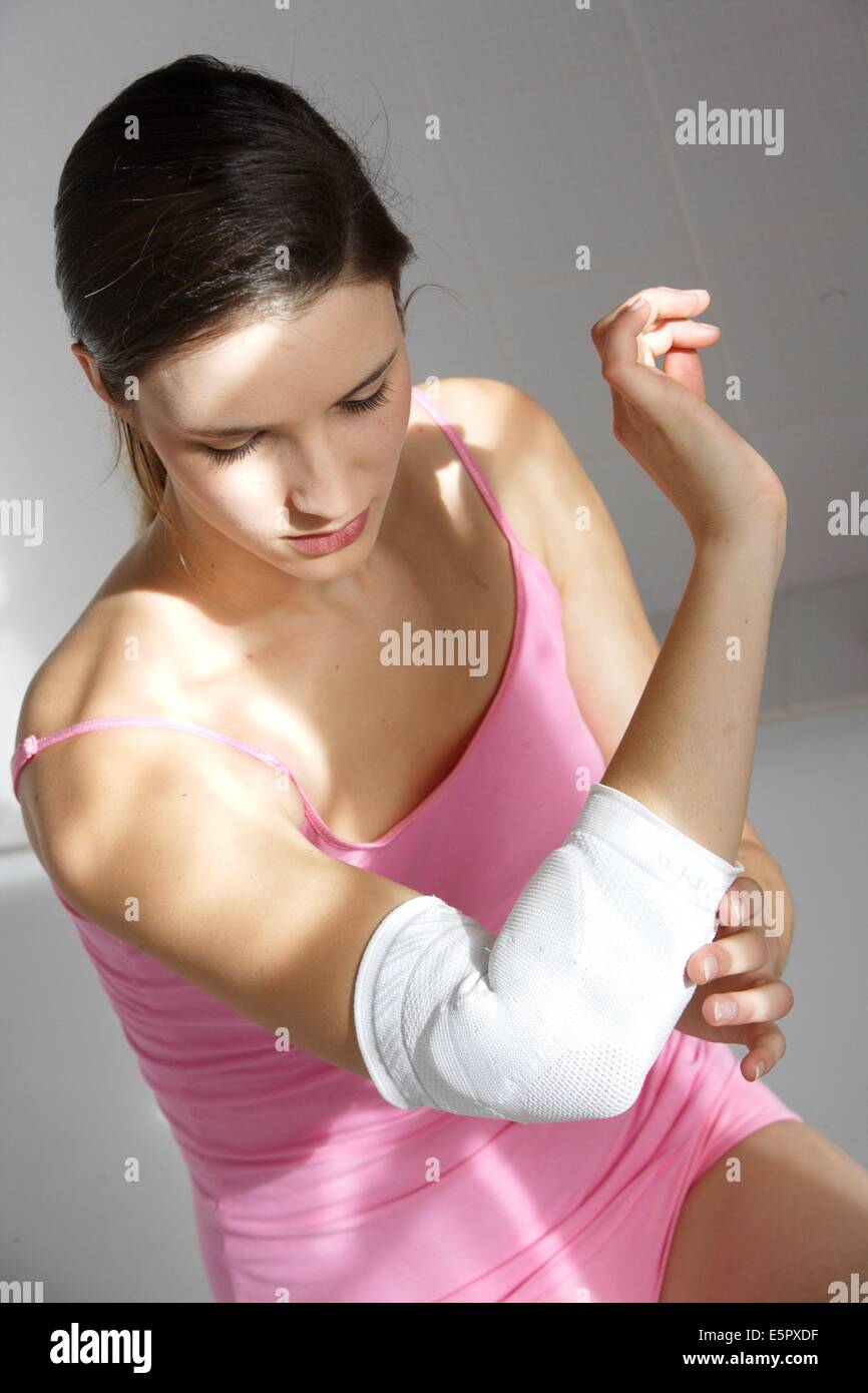 Woman wearing a elbow holder. Stock Photo