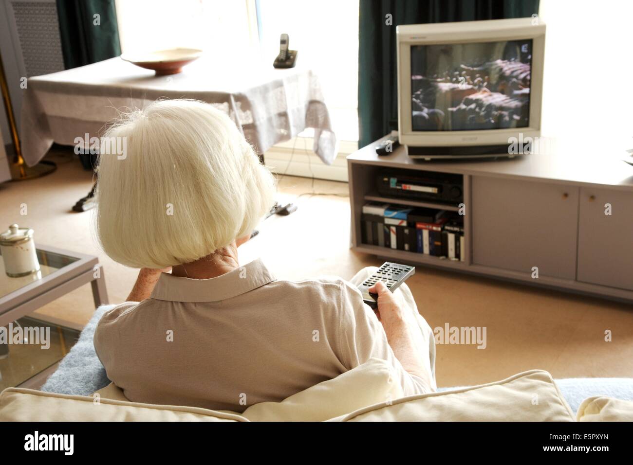 Elderly woman watching TV Stock Photo Alamy