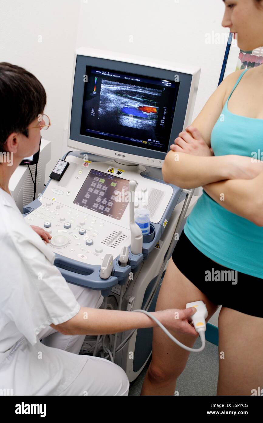 Patient undergoing a Doppler ultrasound (angiodynography) scan of the legs  to study blood flow and explore potential deep vein Stock Photo - Alamy