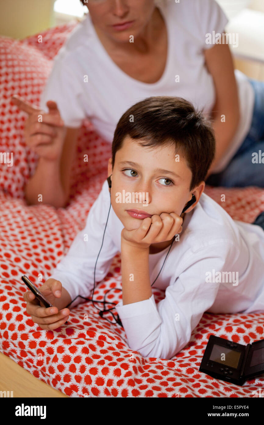 10 year old boy listening to music on MP3 player Stock Photo Alamy