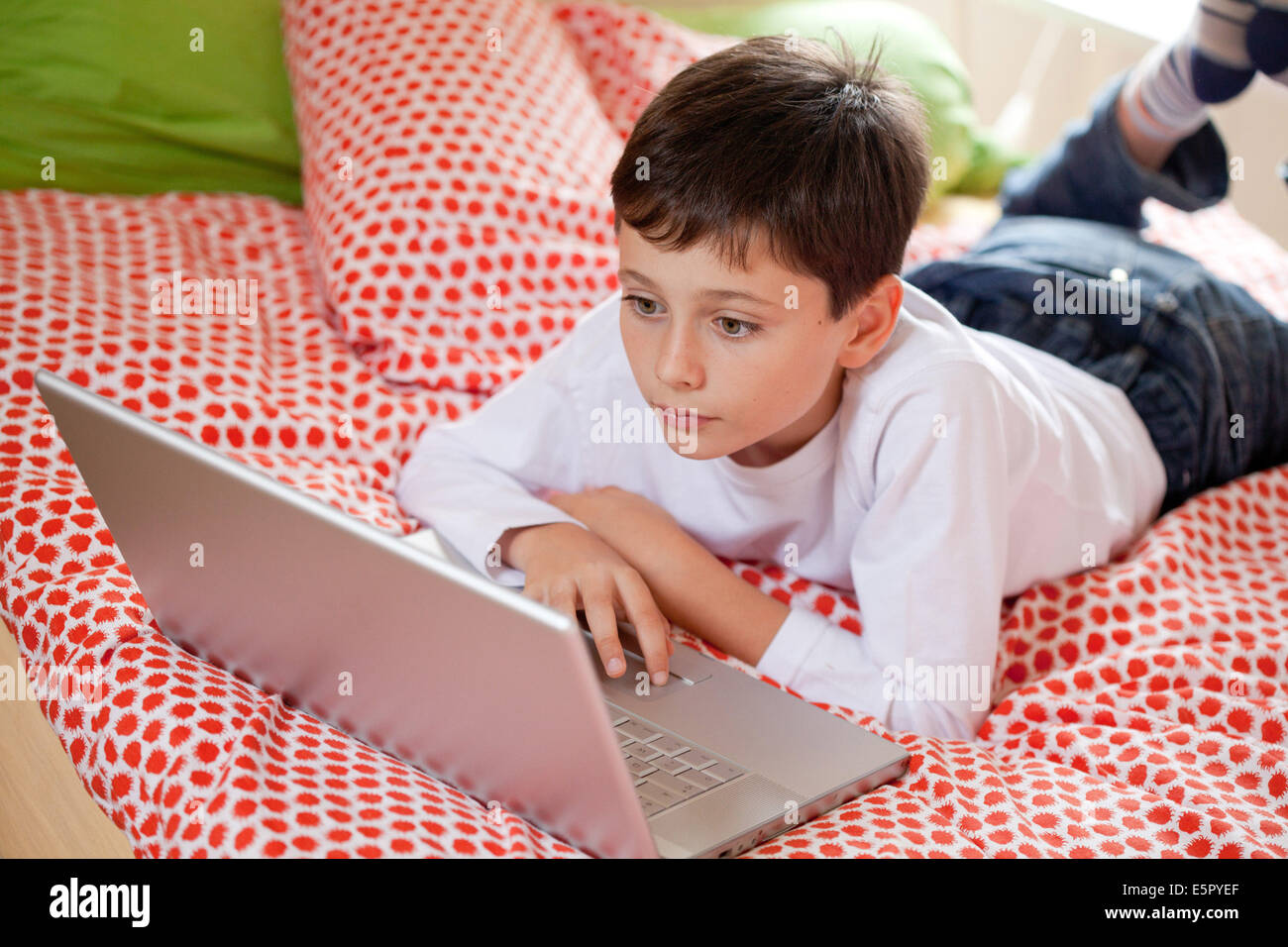 10 year old boy using laptop computer. Stock Photo