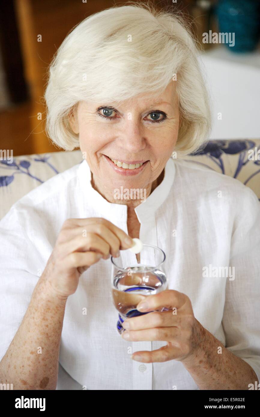 Elderly woman taking an effervescent aspirin tablet Stock Photo Alamy