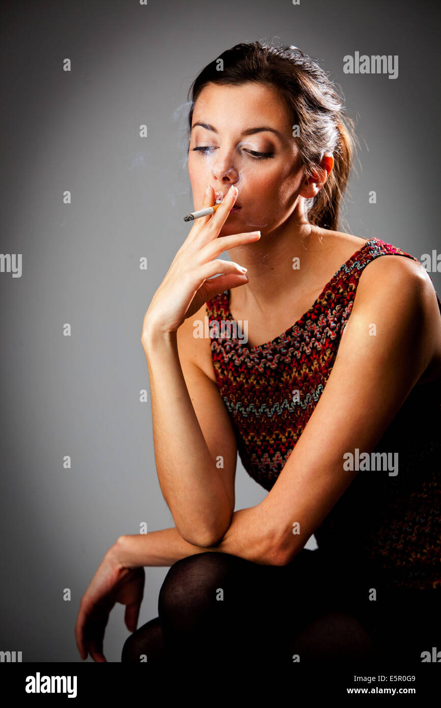 Brunette smoking a cigarette hi-res stock photography and images - Alamy
