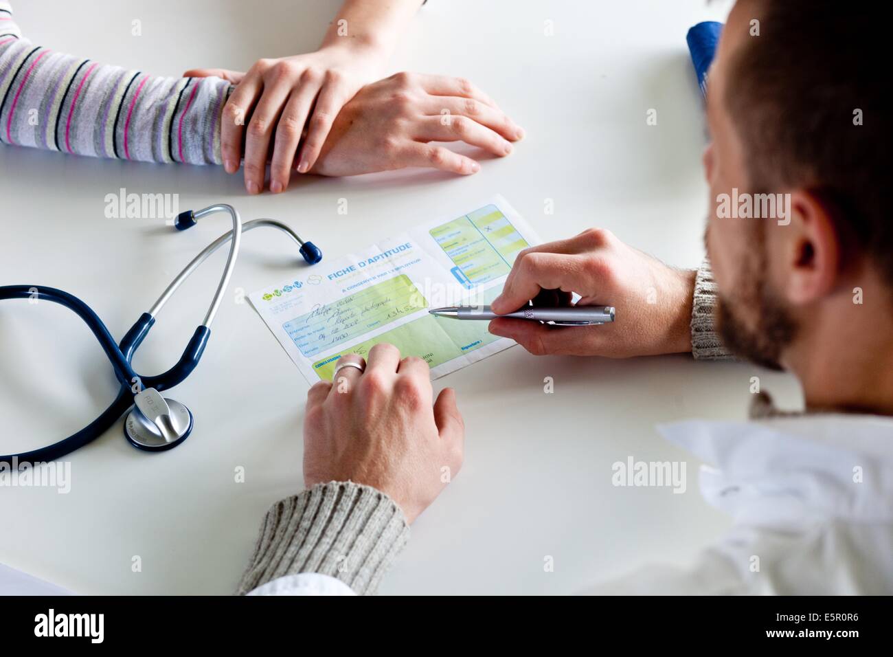 Occupational doctor giving employability document. Stock Photo
