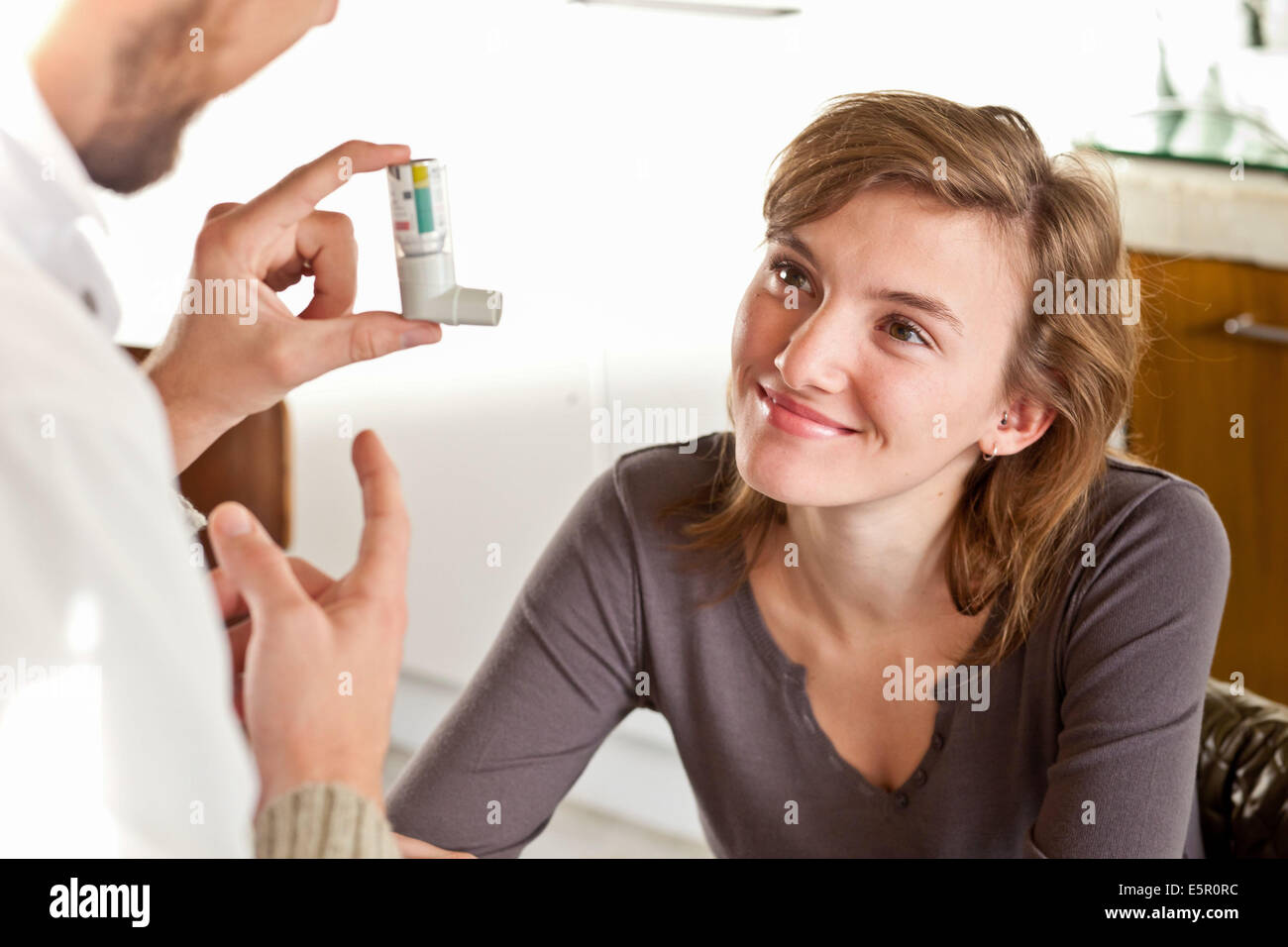 Doctor showing an asthma inhaler to a patient Stock Photo Alamy