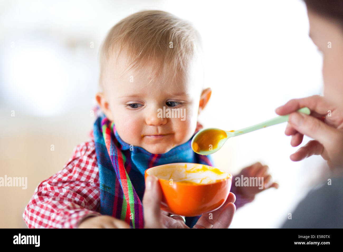 Spoonfeeding 10 month old baby Stock Photo Alamy