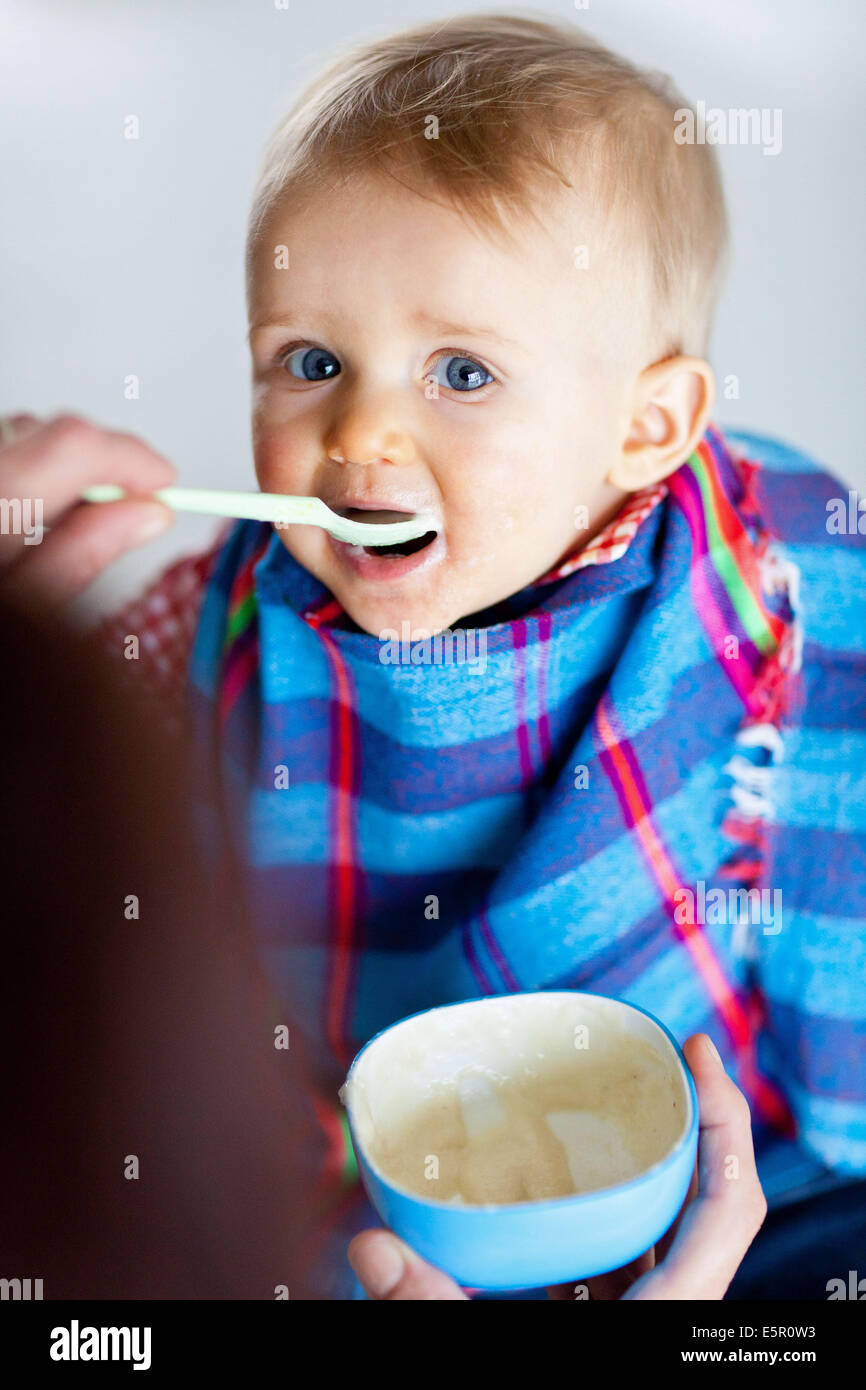 spoon-feeding-10-month-old-baby-stock-photo-alamy