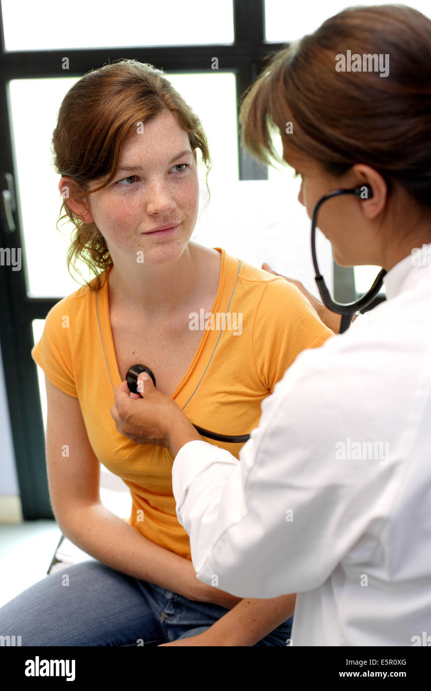 Doctor examining chest of a female teenager with a stethoscope Stock Photo Alamy