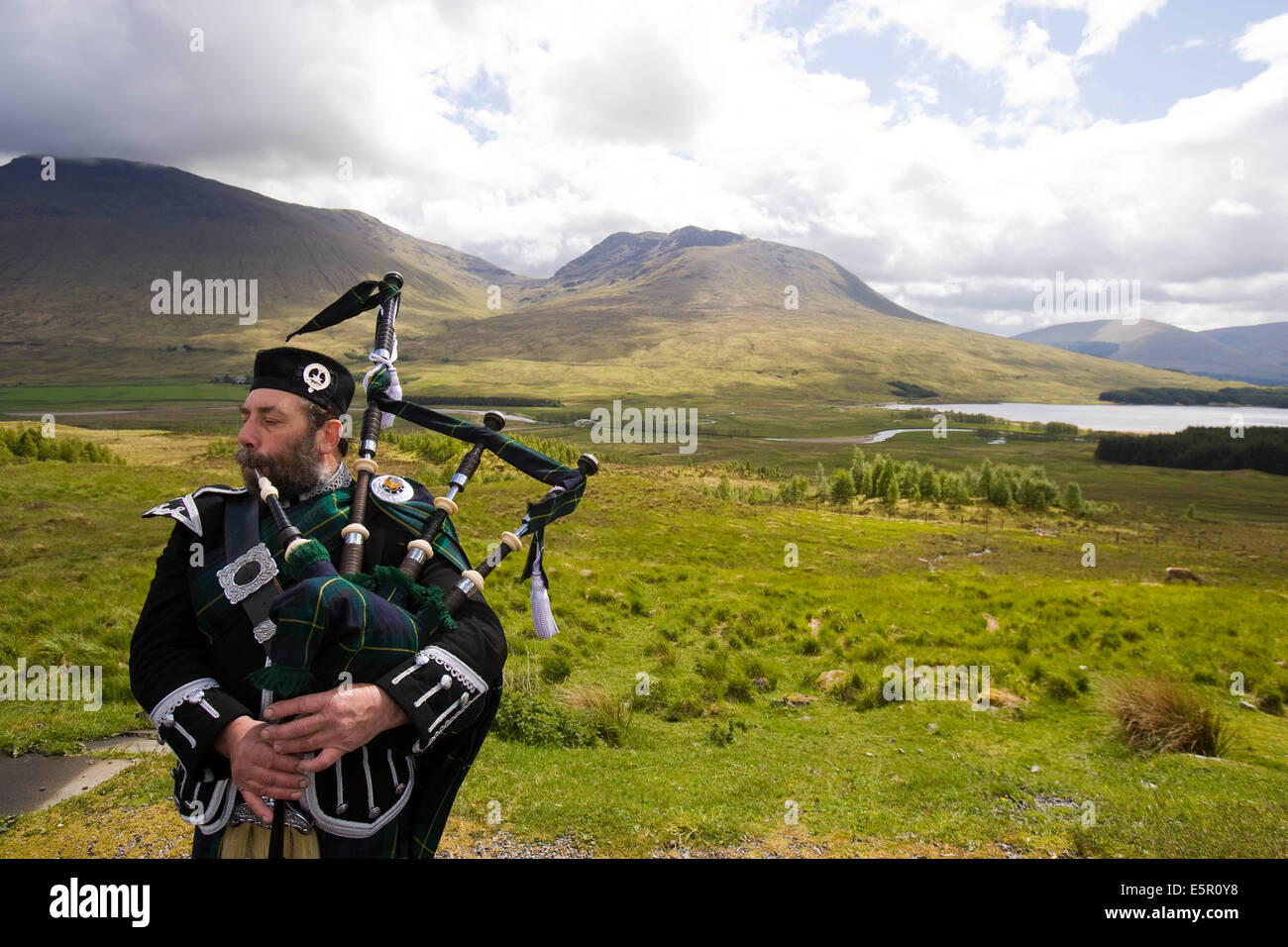 Bagpipe player, Loch Tulla, Scotland. Stock Photo