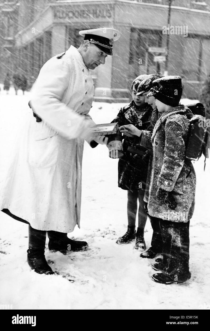 A German soldier collects donations for the winter relief organization of the German People, location and date unknown. Fotoarchiv für Zeitgeschichtee - NO WIRE SERVICE Stock Photo