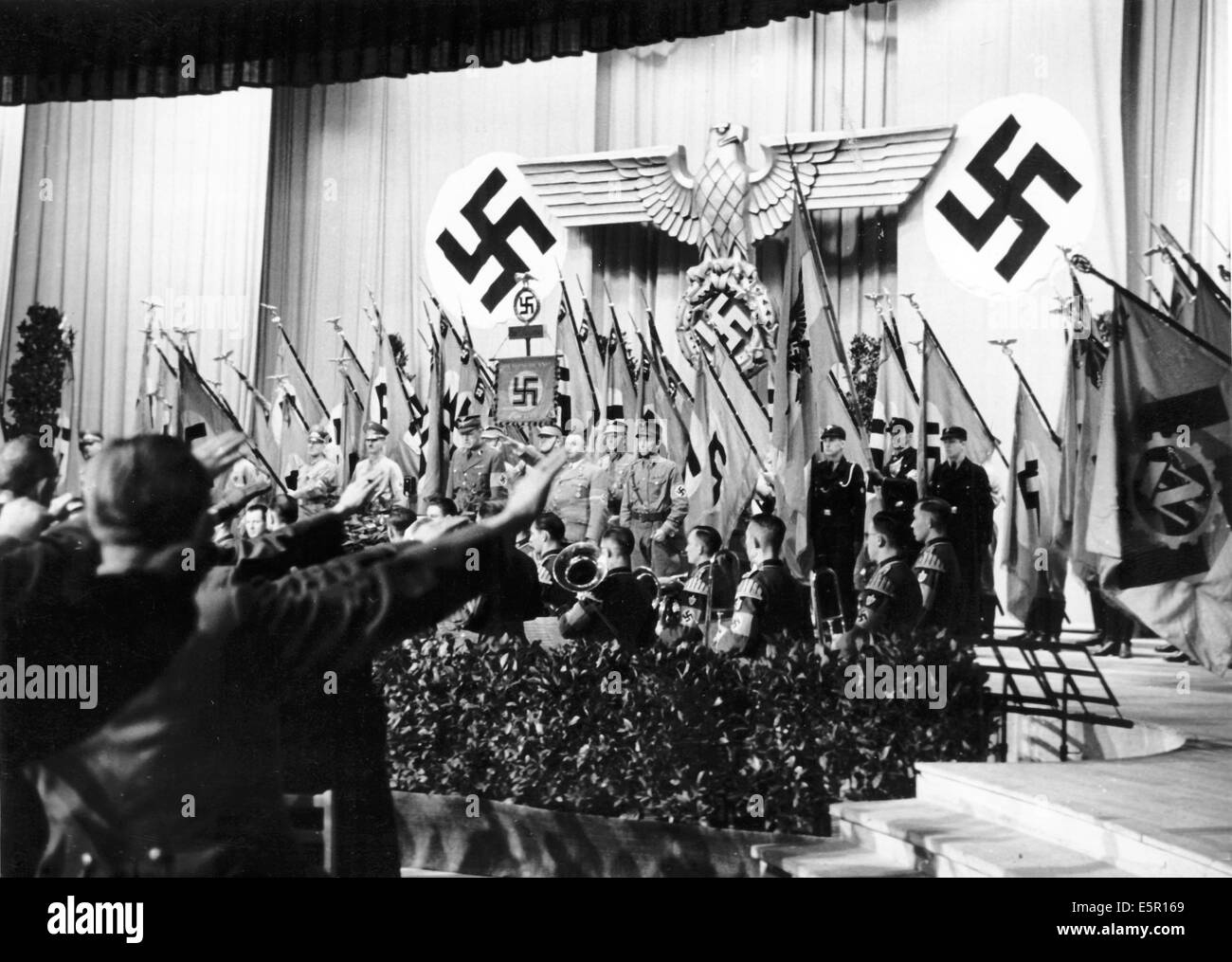 The Nazi propaganda picture shows a commemoration for the Nazis killed during the 1923 Hitler-Ludendorff Coup as well as the falled from the First World War and current war in the Dome Hall of the Reichs Sports Academy in Berlin, Germany, November 1943. The flags are lowered and people perform the Nazi salute during the reading of the names of the fallen from November 09.' Fotoarchiv für Zeitgeschichtee - NO WIRE SERVICE Stock Photo