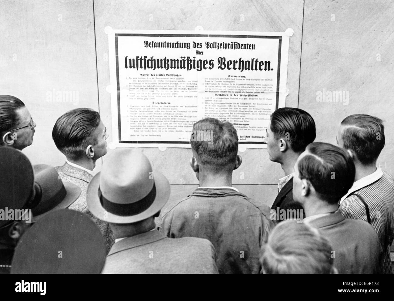 The picture from a Nazi news report shows pedestrians reading a police department announcement about behaviour during an air raid in Berlin, Germany, September 1939. Fotoarchiv für Zeitgeschichte - NO WIRE SERVICE Stock Photo