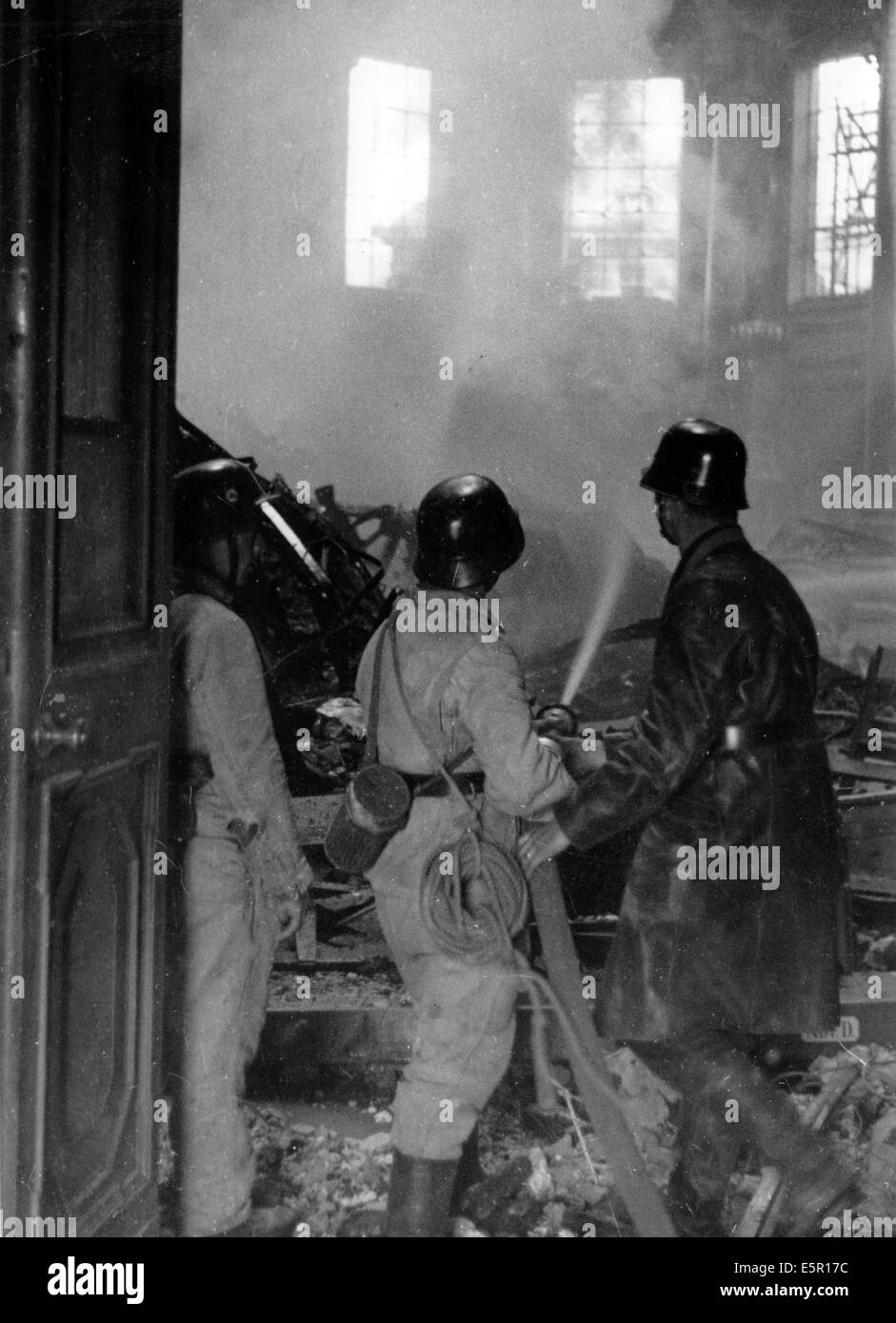 The picture from a Nazi news report shows firemen putting out a fire in ...
