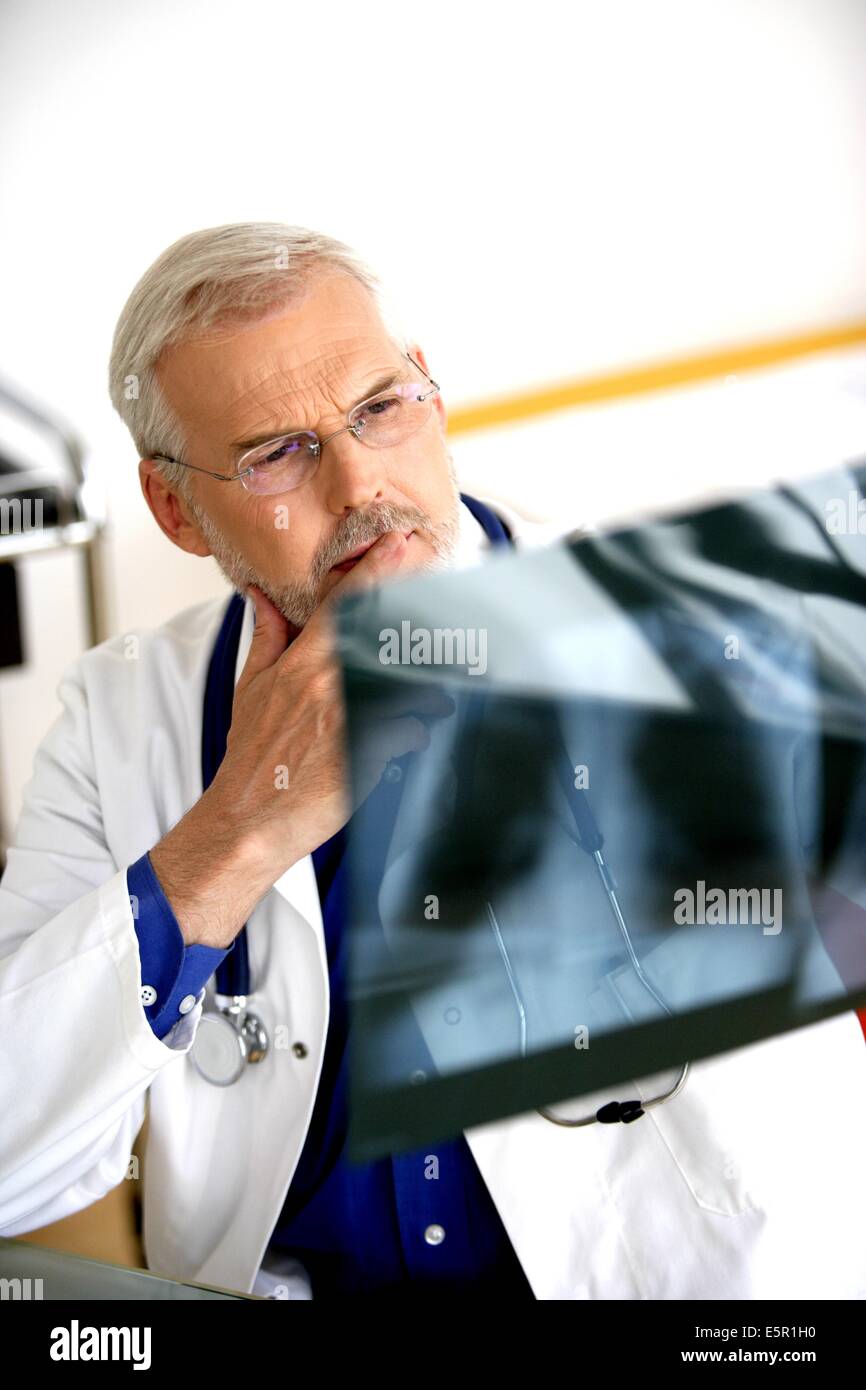 Doctor examining Xrays Stock Photo Alamy
