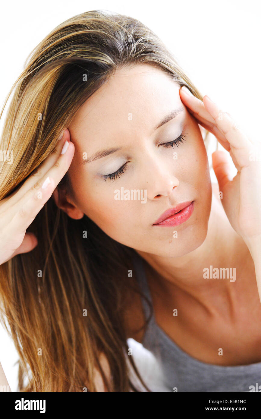 Woman with hands on temples Stock Photo - Alamy