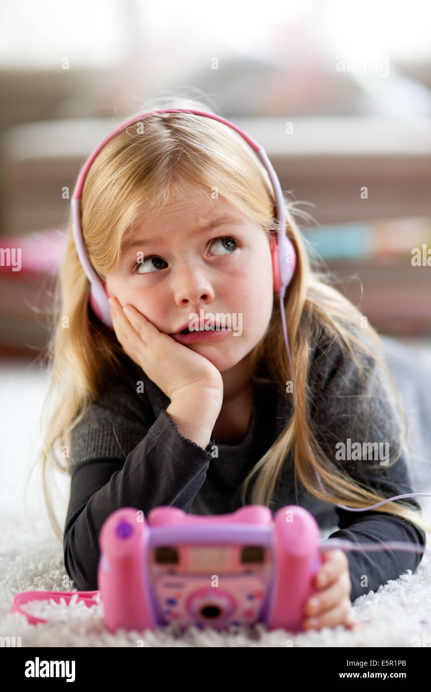 5 year old girl listening music with mp3 player toy Stock Photo - Alamy