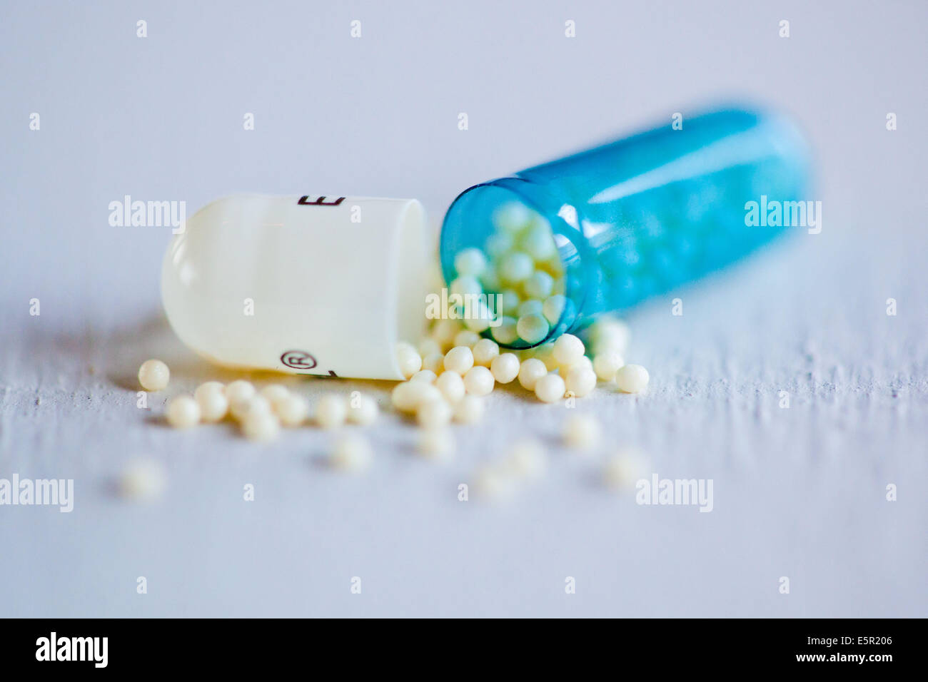 Opened drug capsule. Stock Photo