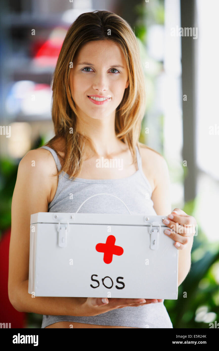 Woman with first aid box. Stock Photo
