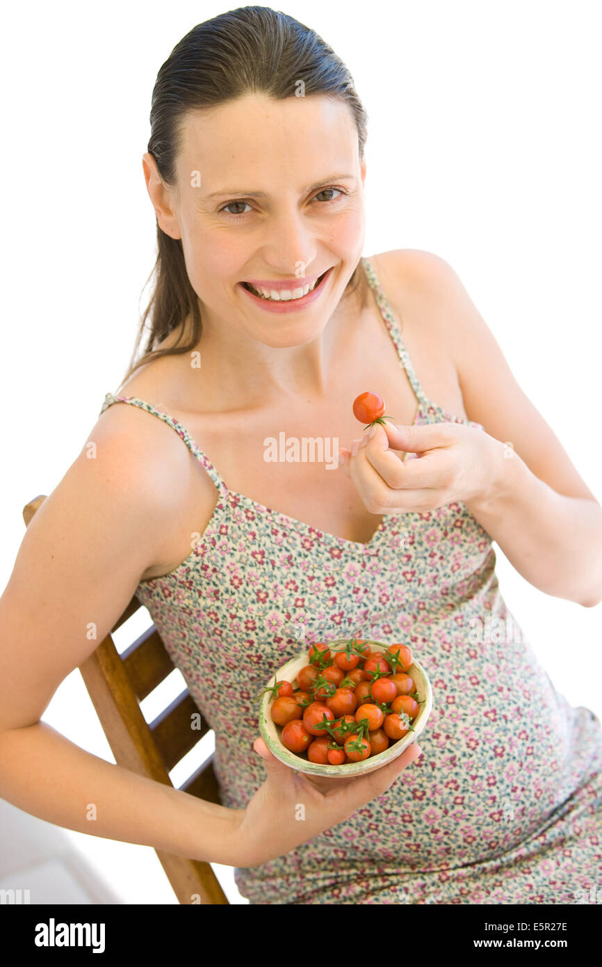 Pregnant woman eating tomatoes Stock Photo Alamy