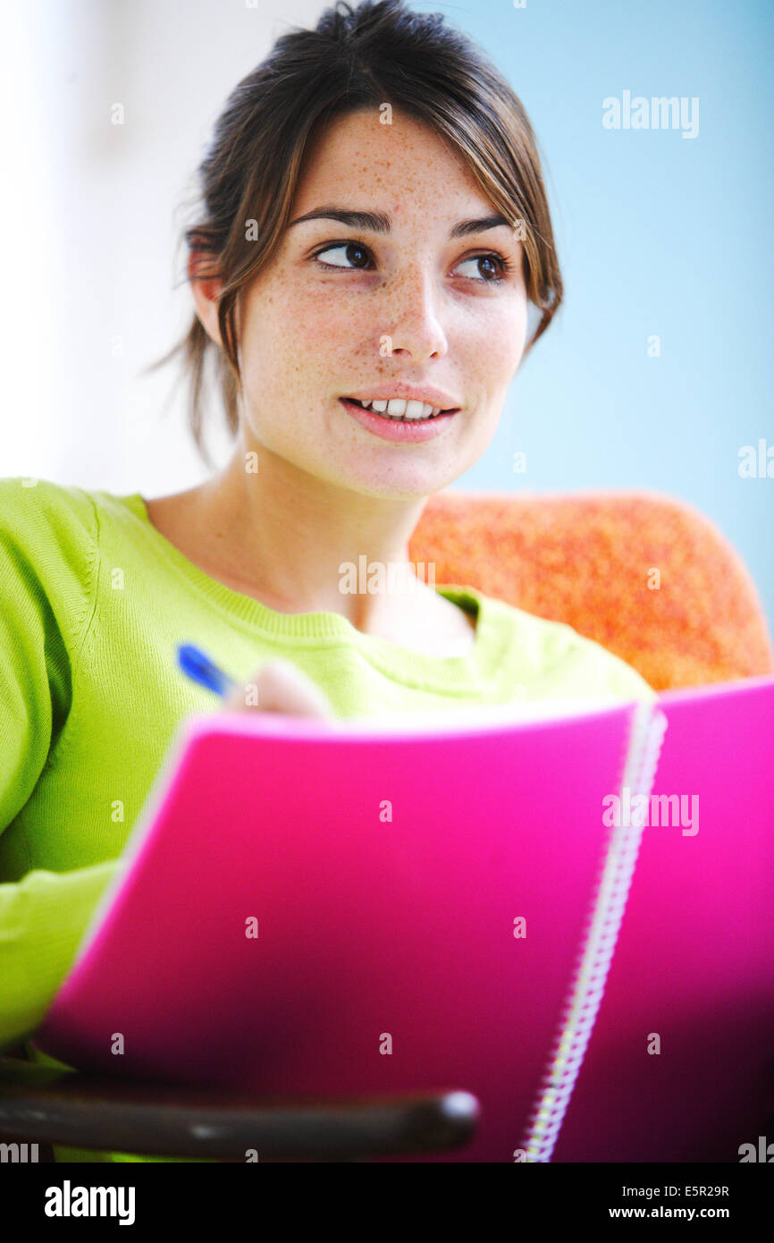 Woman writing in notebook. Stock Photo