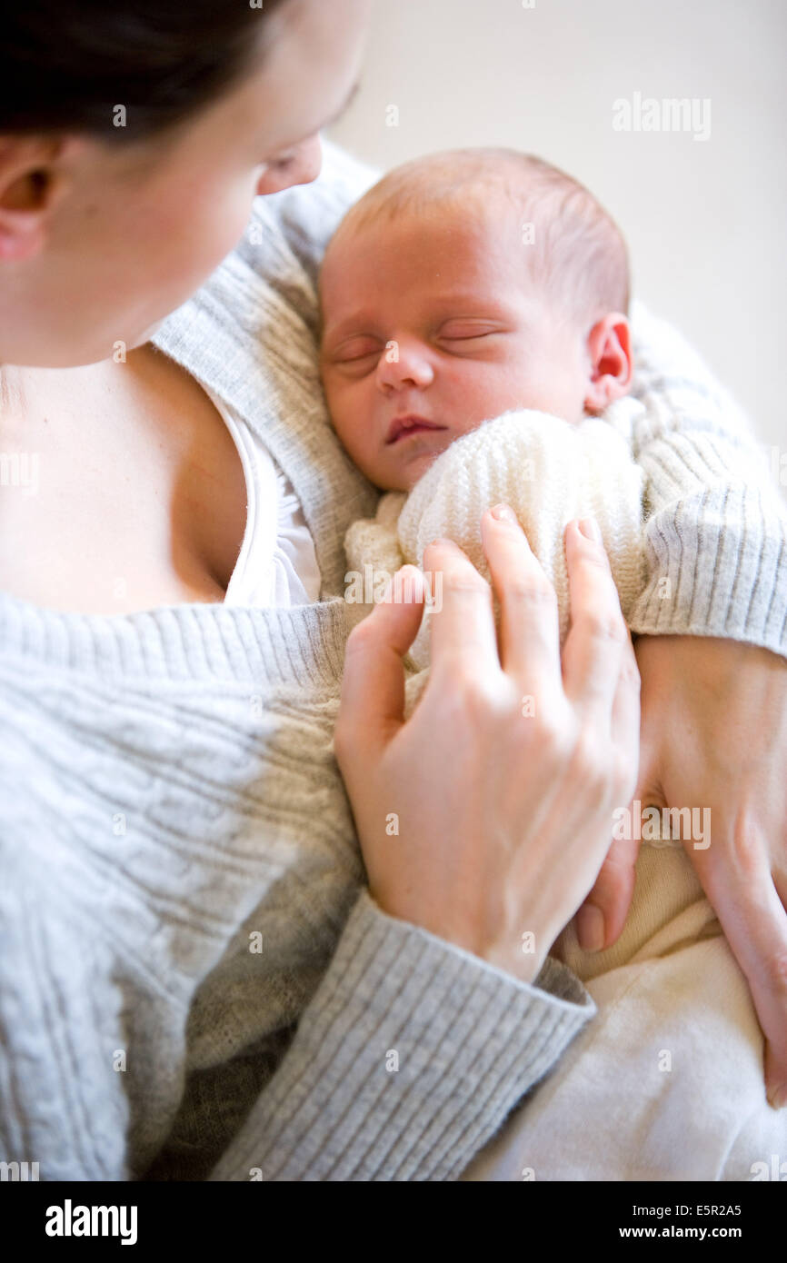 3 weeks old baby with his mother. Stock Photo