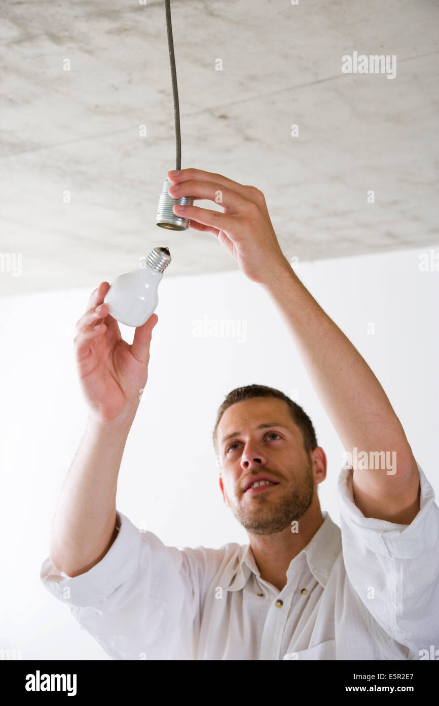 Man changing a light bulb Stock Photo Alamy