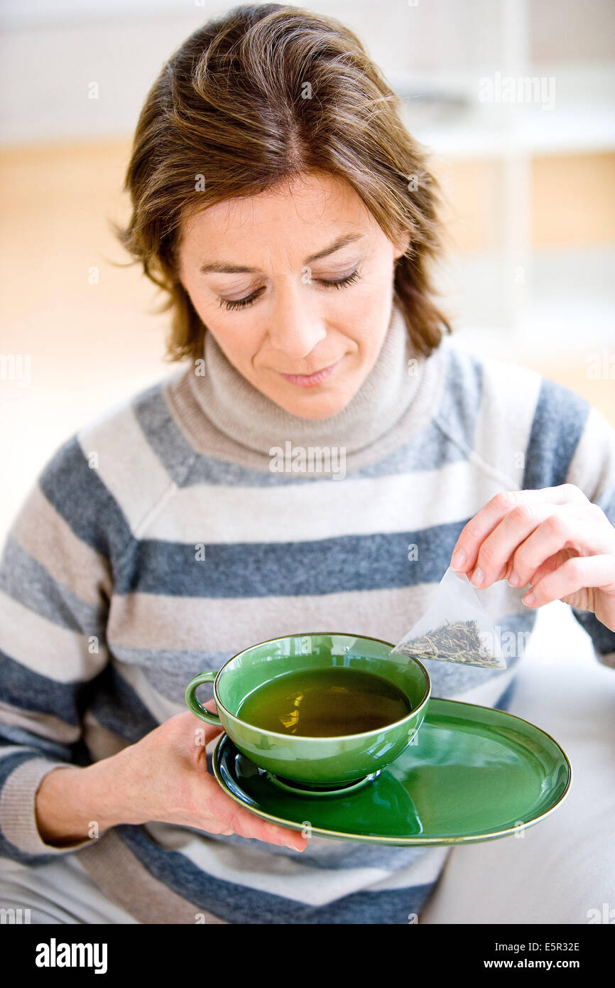 Woman drinking hot beverage Stock Photo Alamy
