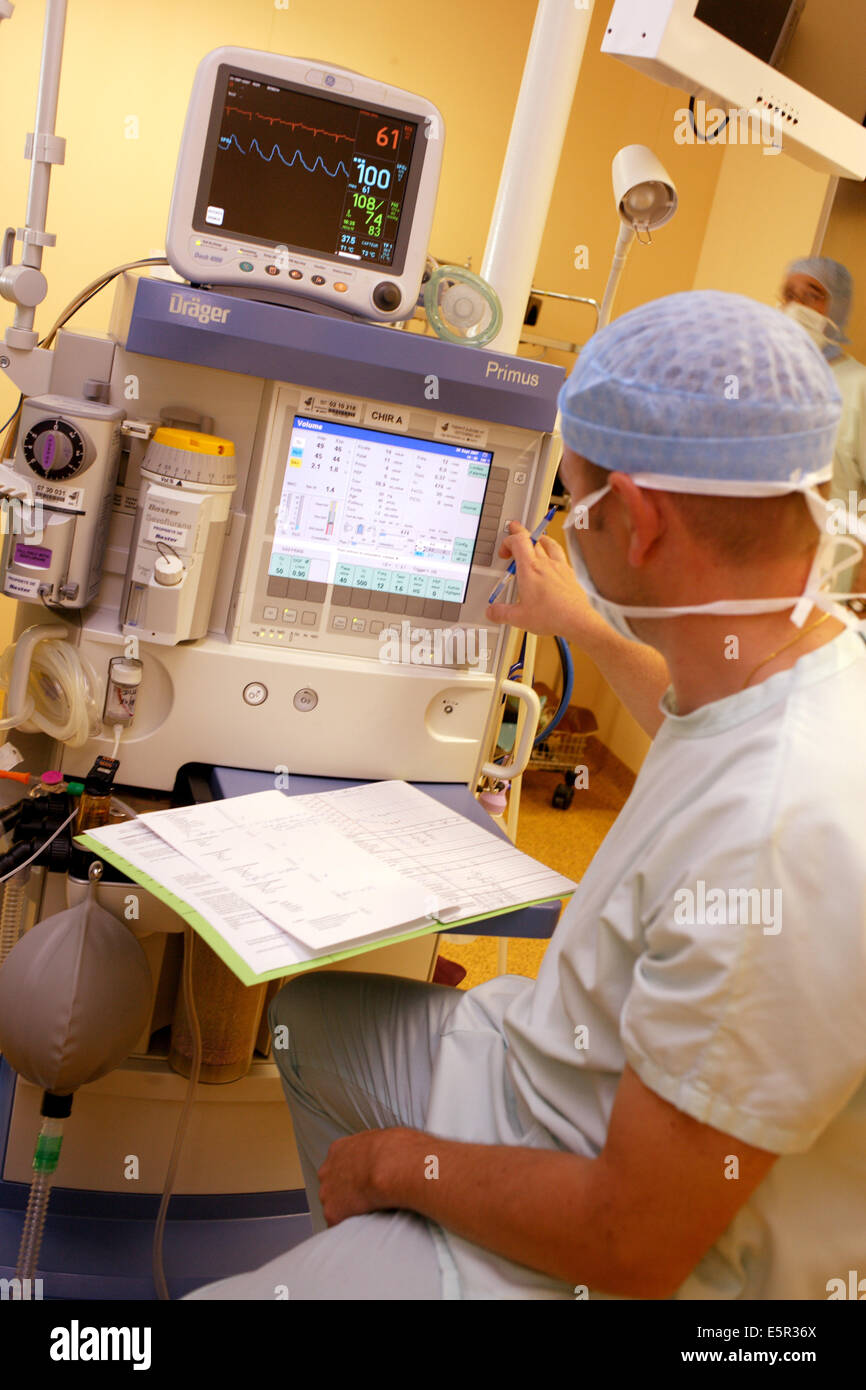 Anaesthetist beside anaesthetic monitoring equipment during surgery, Department of