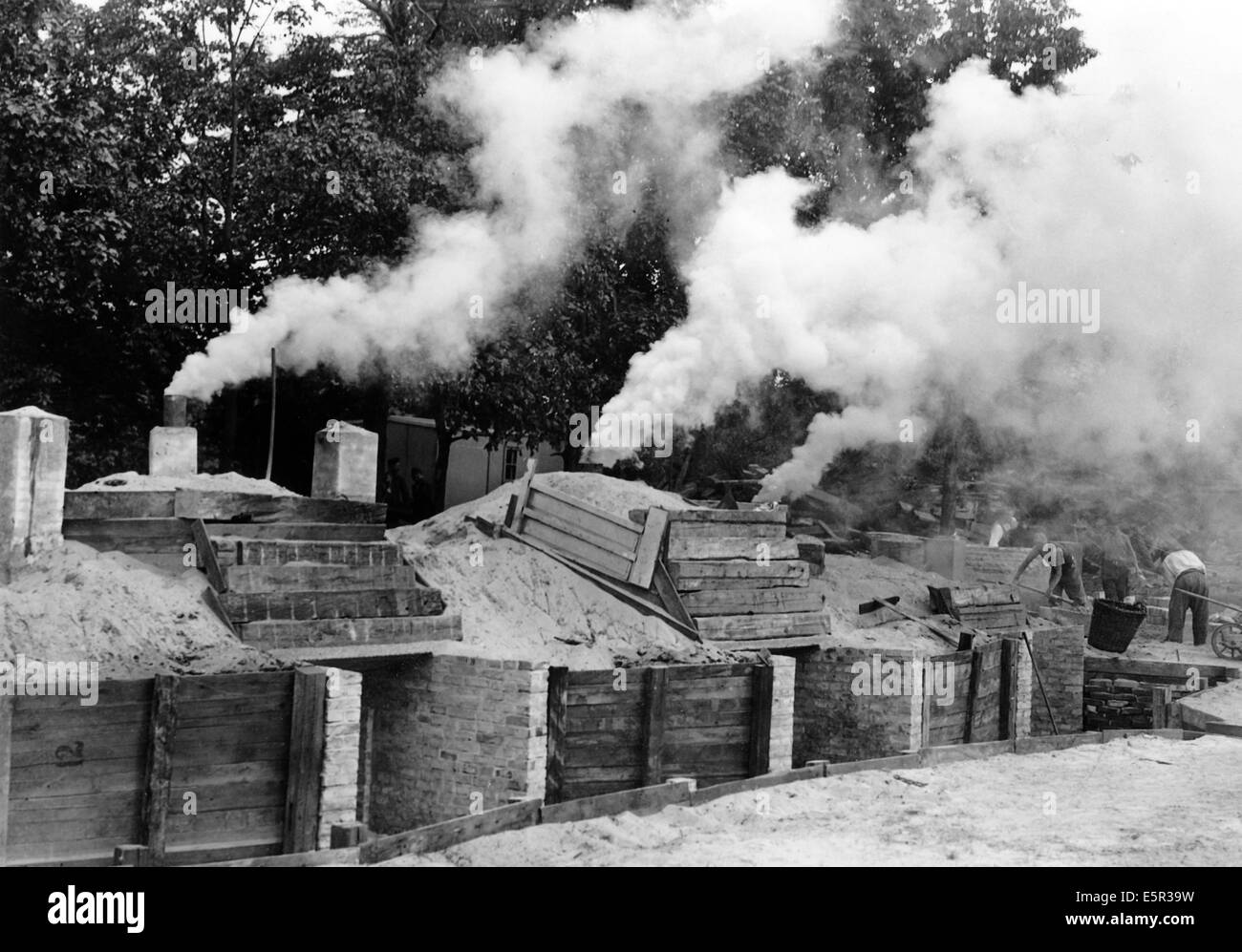 The picture from a Nazi news report shows charcoal piles to simplify the process of providing charcoal to wood gas powered vehicles in Berlin, Germany, September 1944. The wood, which was no longer suitable for construction, was collected from the rubble in the city. Fotoarchiv für Zeitgeschichtee - NO WIRE SERVICE Stock Photo
