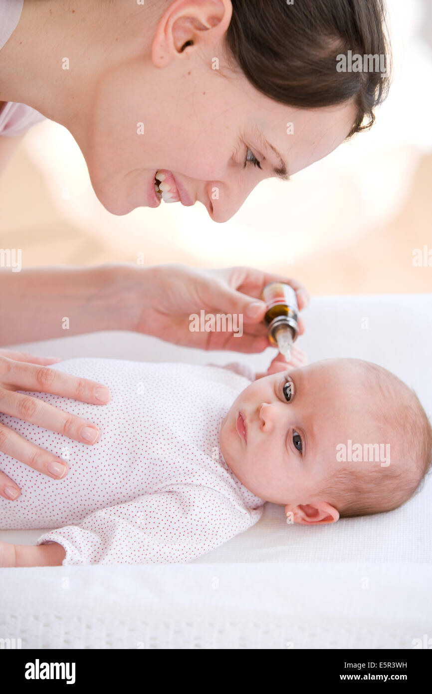 2 month old baby receiving ear drops Stock Photo Alamy