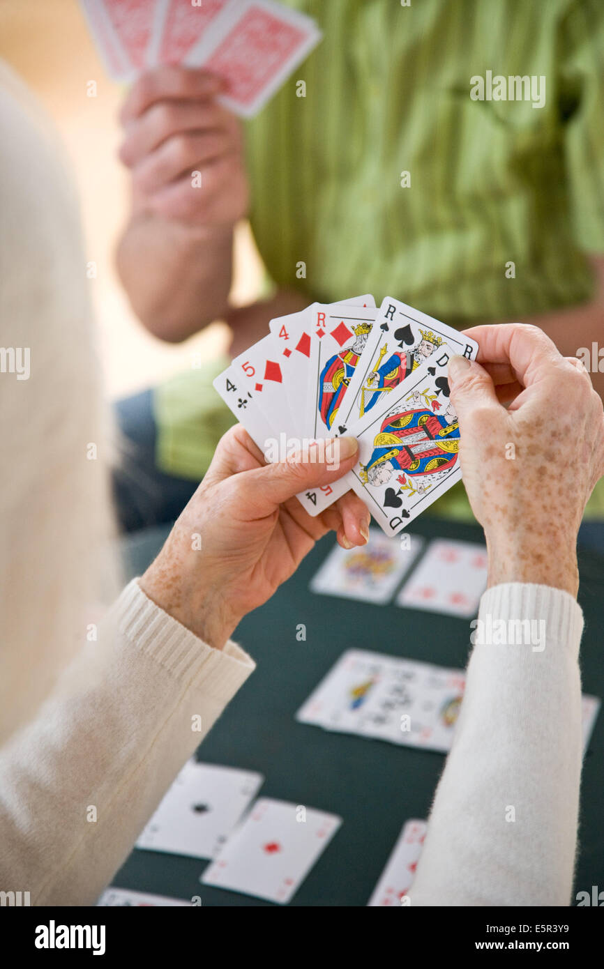 Elderly woman playing cards Stock Photo Alamy