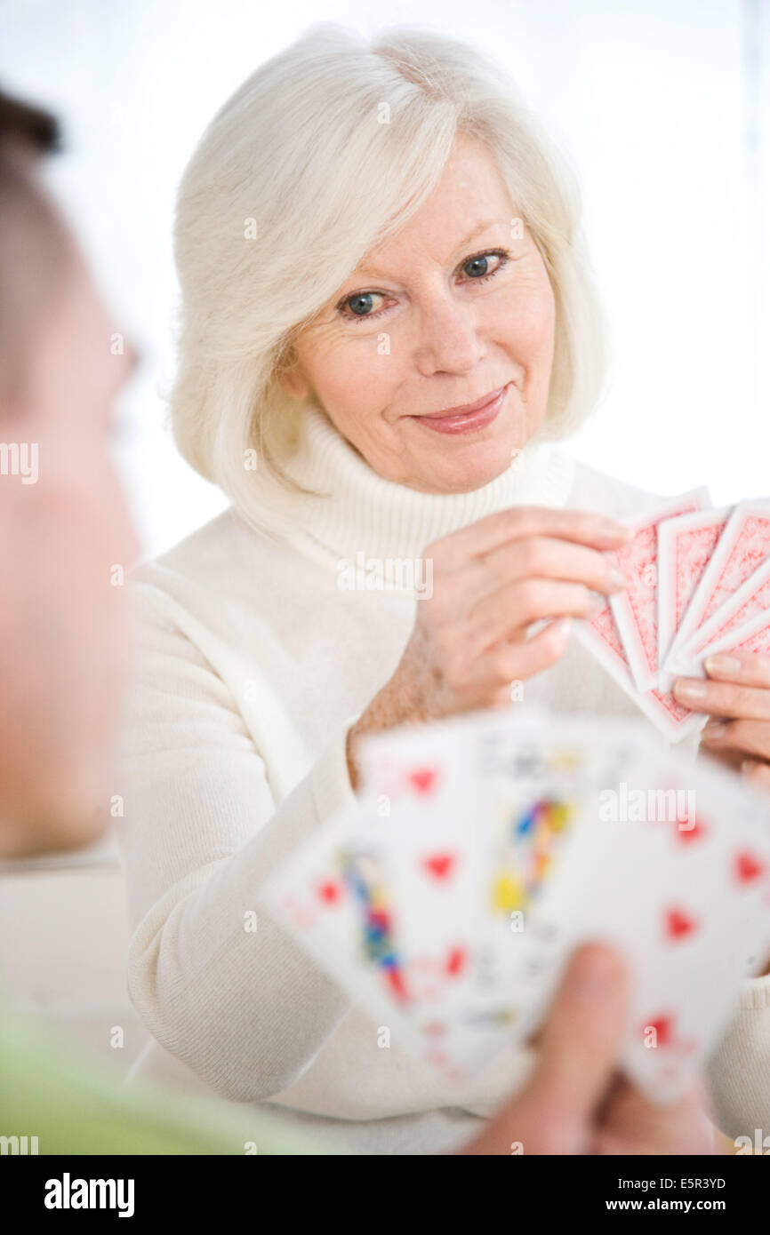 Elderly woman playing cards Stock Photo Alamy