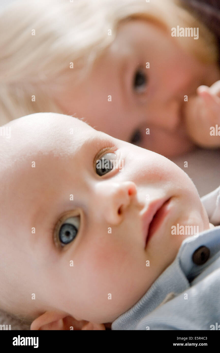 9 months old baby with his sister. Stock Photo