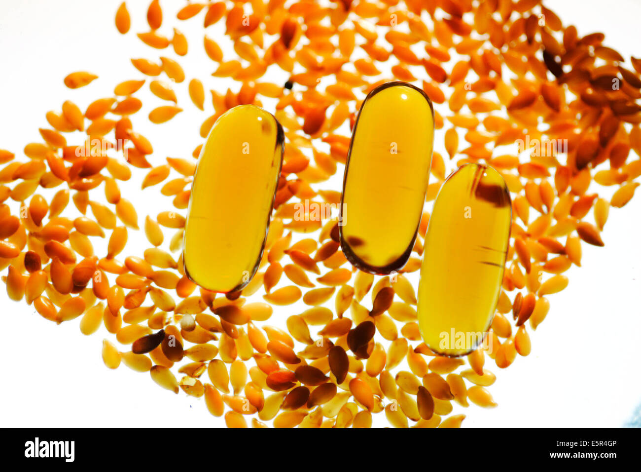 Golden flax seeds, rich in omega 3 and oil capsules Stock Photo Alamy