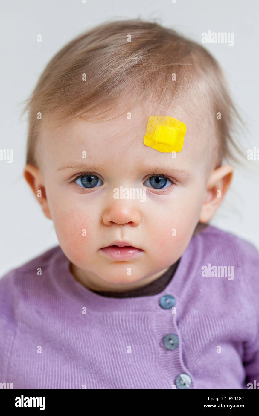 13monthold baby girl with bandaid on forehead Stock Photo Alamy