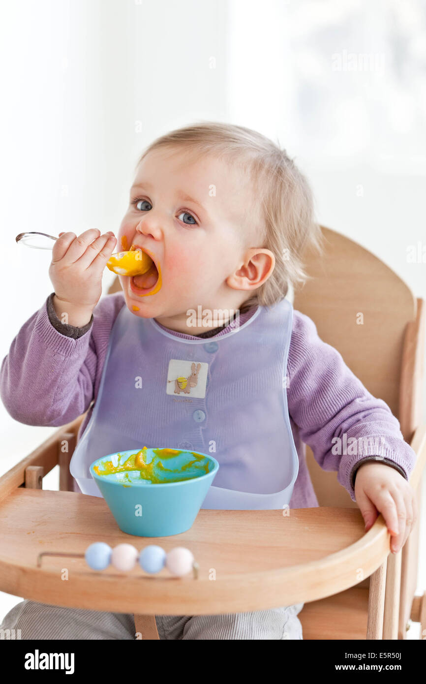 Month old baby girl eating hi-res stock photography and images - Alamy