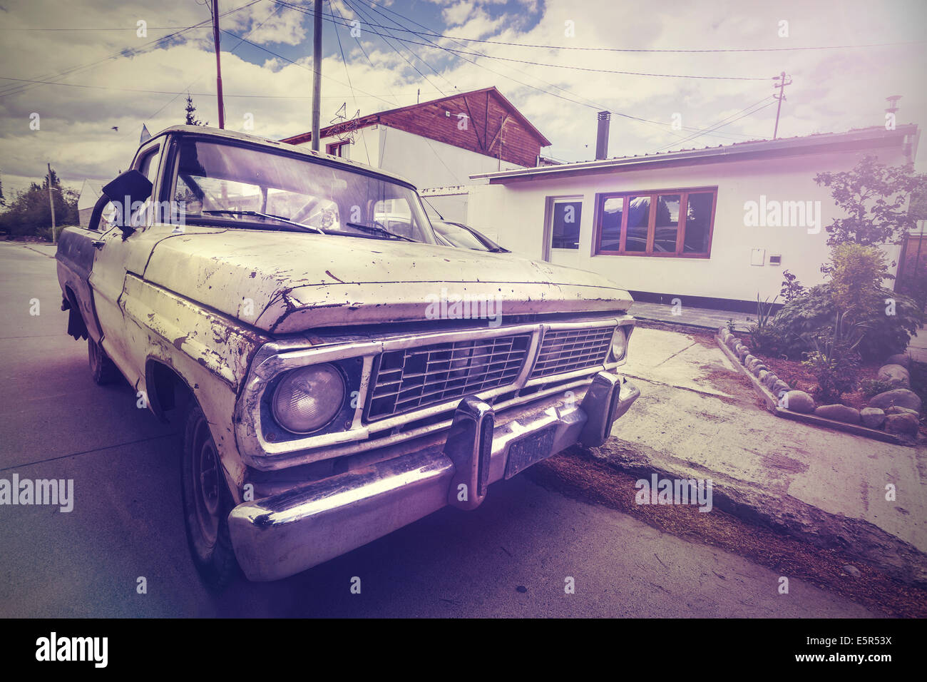 Vintage picture old broken car on a village road Stock Photo