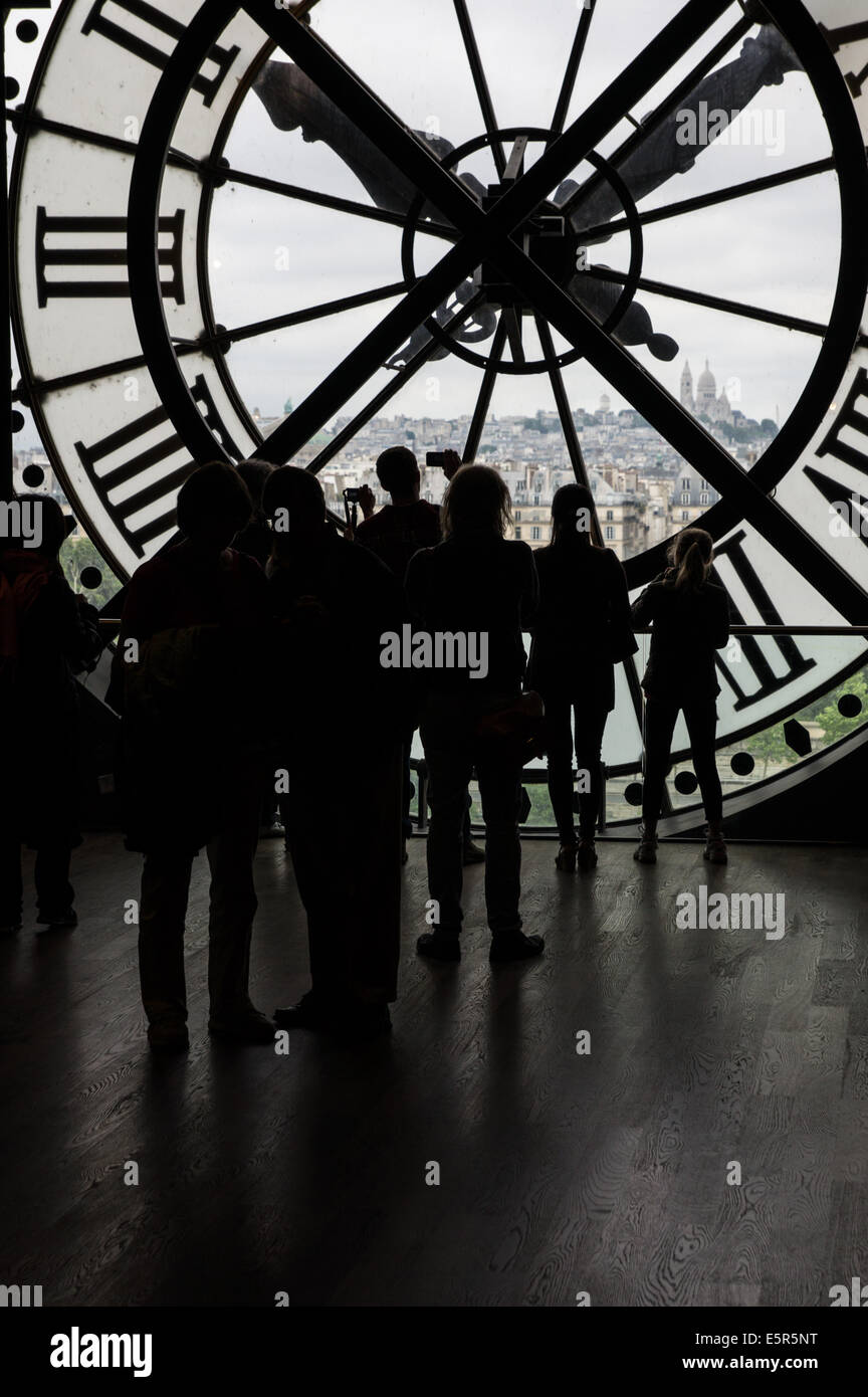 People looking through the clock in the Musee d'Orsay in Paris, France Stock Photo