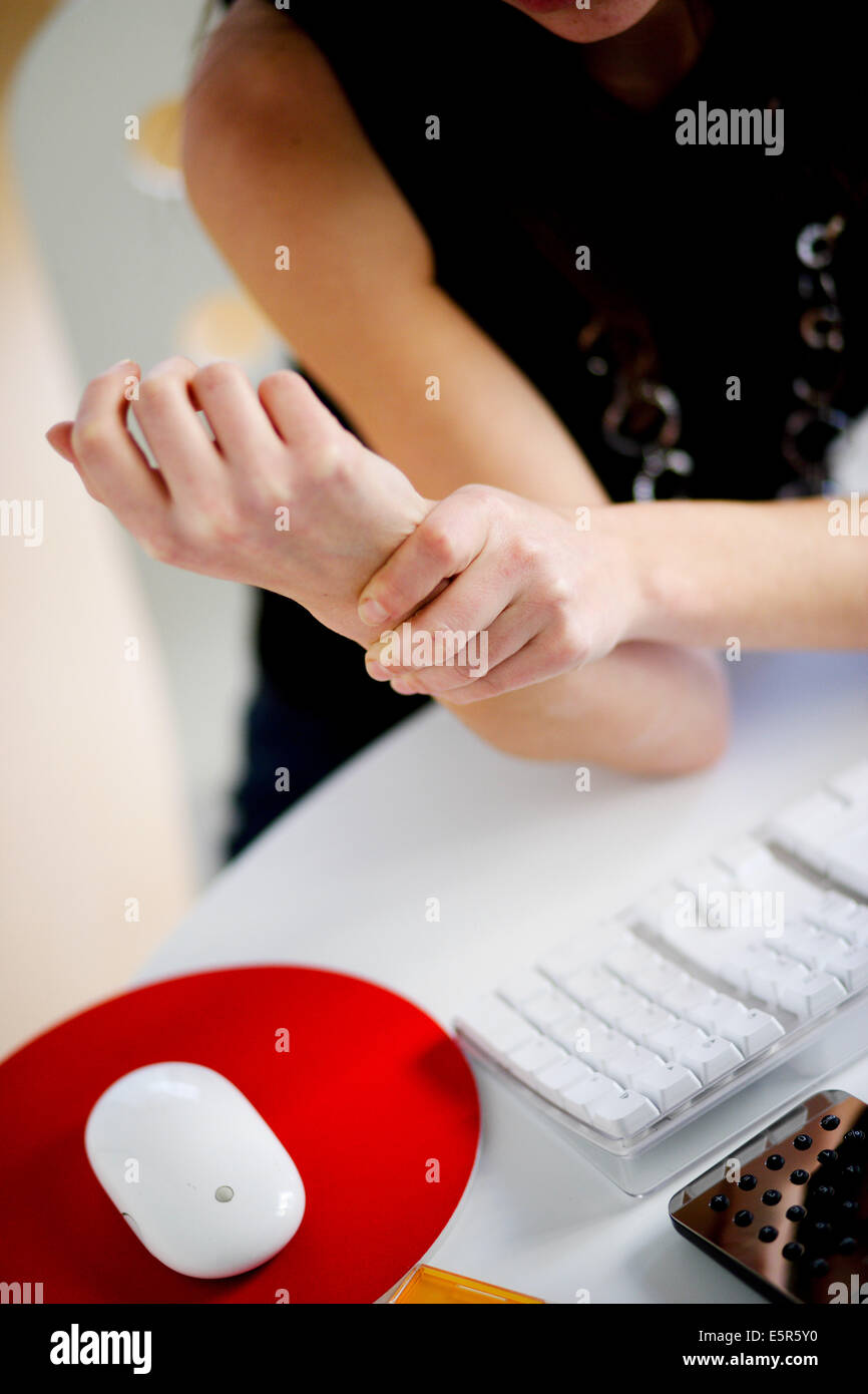 Woman at work suffering from wrist pain. Stock Photo
