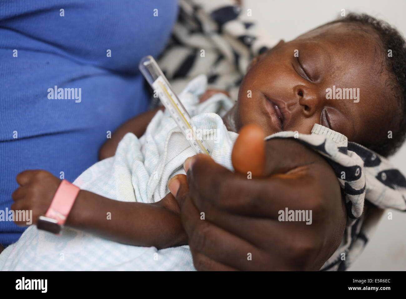 Checking the temperature of children suffering from malnutrition in a