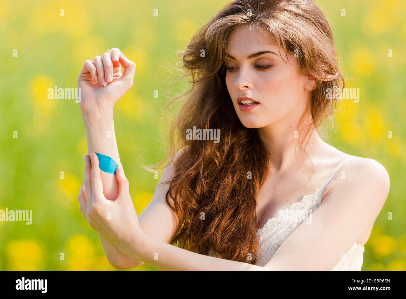 Woman putting a bandaid on arm Stock Photo Alamy