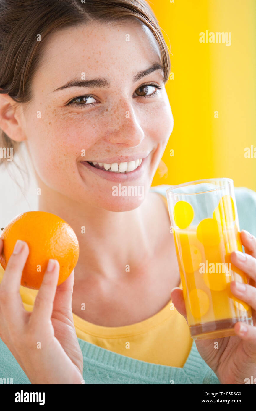 Woman drinking orange juice Stock Photo Alamy