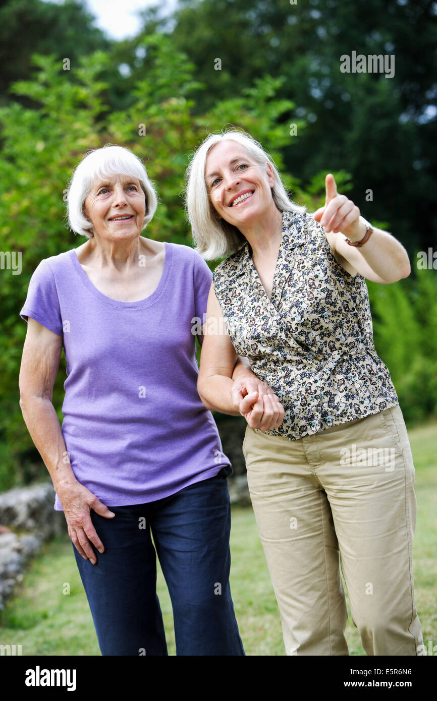 80 year old woman with her daughter going for a walk. Stock Photo
