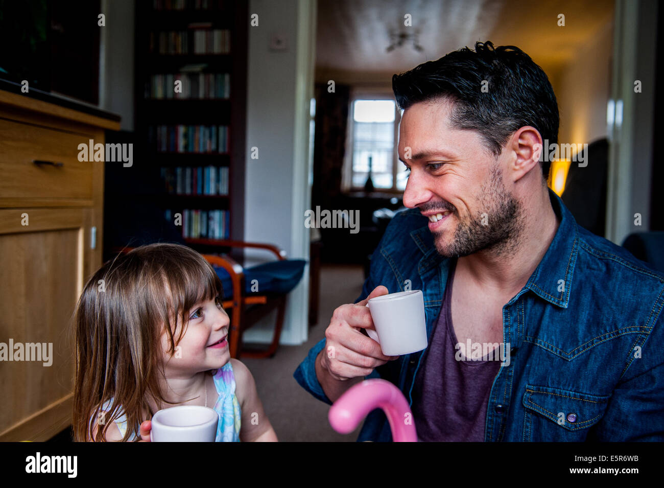 Dad with his daughter 6 7 8 years old playing kitchens Stock Photo