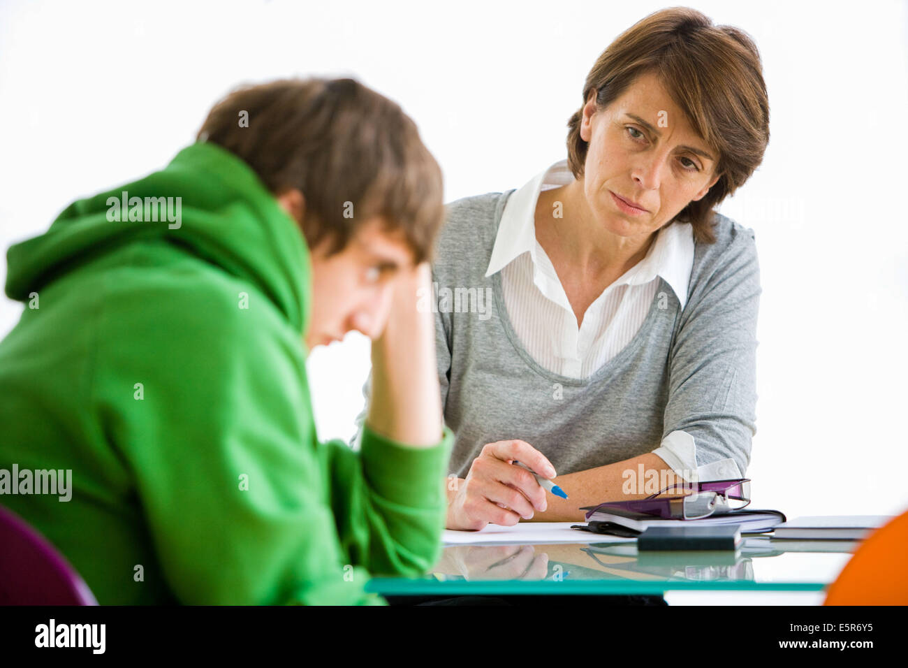 Teenage boy talking with specialist or teacher. Stock Photo